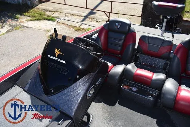 Slide: The Image of 2015 Triton 189 TRX boat interior with red and black seats, Humminbird electronics. - 25