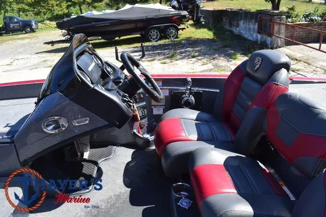 Slide: The Image of 2015 Triton 189 TRX boat interior with red and black seats, steering wheel, and dashboard. - 26