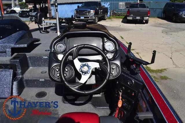 Slide: The Image of 2015 Triton 189 TRX boat dashboard with steering wheel and controls. - 27