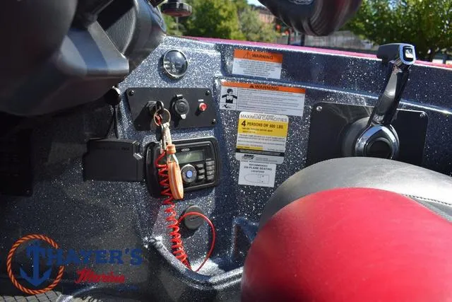 Slide: The Image of 2015 Triton 189 TRX boat dashboard with controls and safety features. - 28