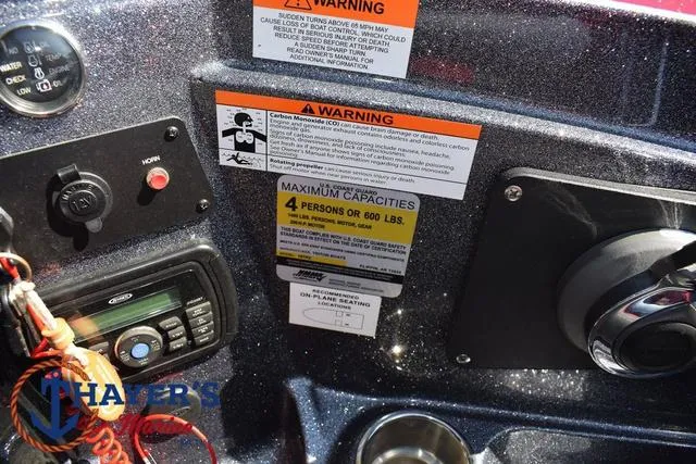 Slide: The Image of Dashboard of a 2015 Triton 189 TRX boat with warning labels and capacity information. - 31