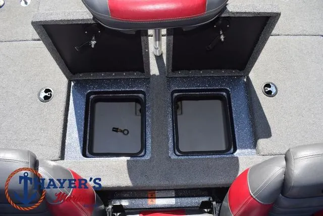 Slide: The Image of 2015 Triton 189 TRX boat storage compartments with open lids, featuring red and gray seating. - 36