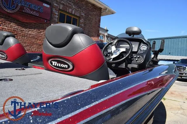 Slide: The Image of 2015 Triton 189 TRX boat with red and gray seats, displayed at Thayer's Marine. - 39