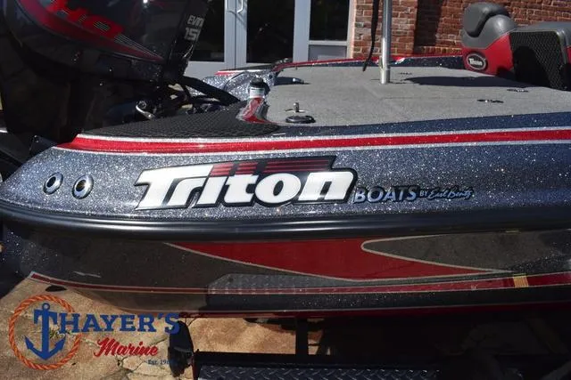 Slide: The Image of 2015 Triton 189 TRX boat with Thayer's Marine logo, featuring sleek design and branding. - 4