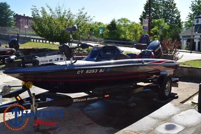 Slide: The Image of 2015 Triton 189 TRX bass boat on trailer, parked outdoors. - 8