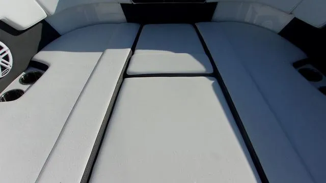 Slide: The Image of 2023 Monterey M-225 boat interior with cushioned seating and cup holders. - 10