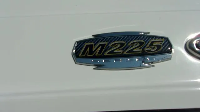 Slide: The Image of 2023 Monterey M-225 boat emblem on white surface. - 13