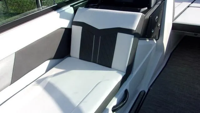 Slide: The Image of 2023 Monterey M-225 boat interior with sleek black and white seating design. - 7