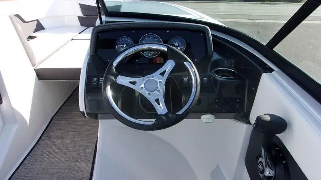 Slide: The Image of 2023 Monterey M-225 boat dashboard with steering wheel and gauges. - 8
