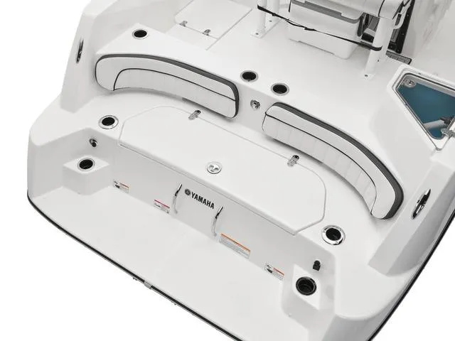 Slide: The Image of 2025 Yamaha Boats 220 FSH Sport, sleek white deck with seating and storage. - 10