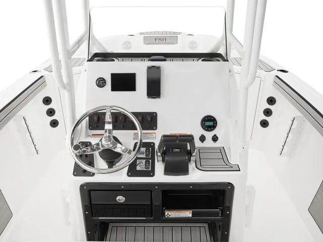 Slide: The Image of 2025 Yamaha Boats 220 FSH Sport dashboard with steering wheel and controls. - 6