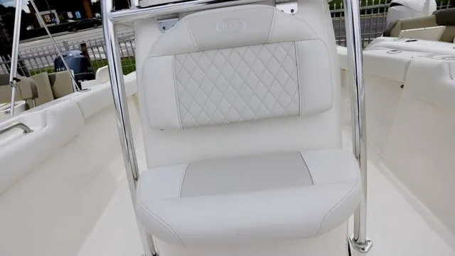 Slide: The Image of 2025 Key West 203 FS boat interior with white cushioned seating and chrome accents. - 14