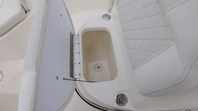 Slide: The Image of 2025 Key West 203 FS boat seat with storage compartment open. - 15