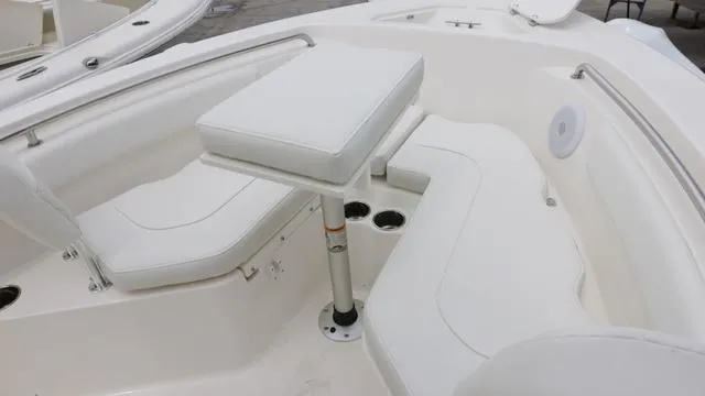 Slide: The Image of 2025 Key West 203 FS boat interior with white seating and table. - 17