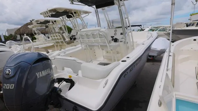 Slide: The Image of 2025 Key West 203 FS boat with Yamaha 200 engine, docked in a marina. - 2