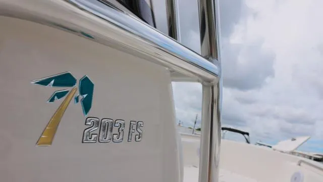 Slide: The Image of Key West 203 FS 2025 boat detail with logo and railing. - 3