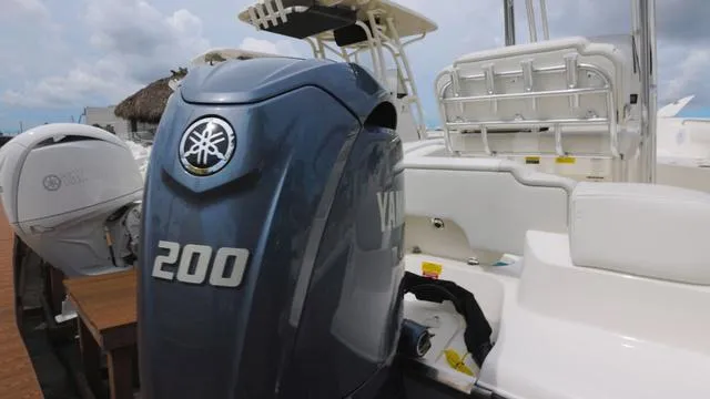 Slide: The Image of 2025 Key West 203 FS boat with Yamaha 200 outboard motor, docked under cloudy skies. - 4