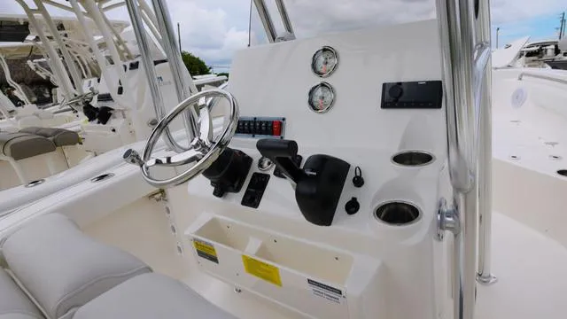 Slide: The Image of 2025 Key West 203 FS boat console with steering wheel and gauges. - 8