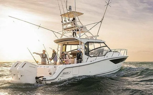 Slide: The Image of 2025 Boston Whaler 365 Conquest boat on ocean, people fishing at sunset. - 6
