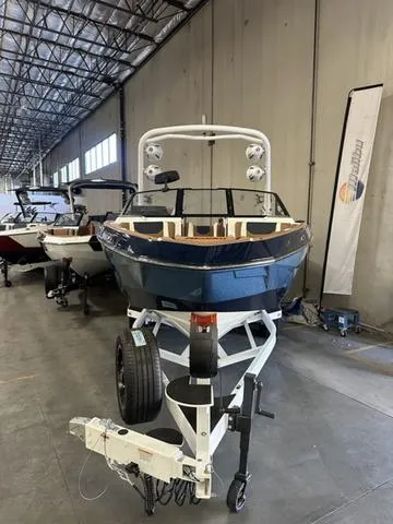 Slide: The Image of 2025 Malibu 25 LSV boat in warehouse, front view on trailer. - 3