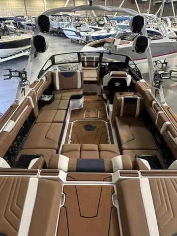 Slide: The Image of 2025 Malibu 25 LSV boat interior with luxurious brown seating and modern design. - 8