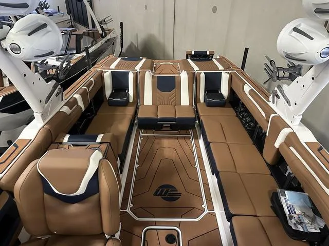 Slide: The Image of 2025 Malibu 25 LSV boat interior with luxurious brown seating and modern design. - 9