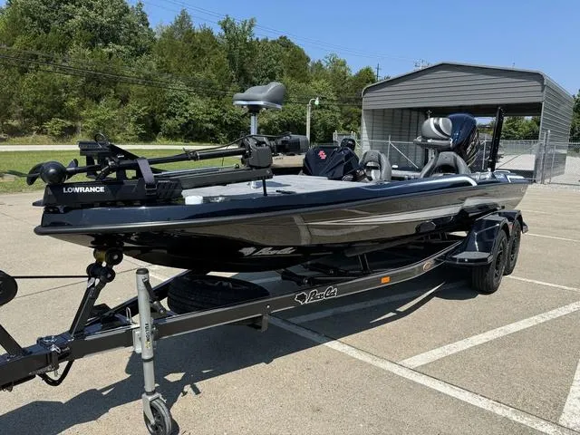 Slide: The Image of 2025 Bass Cat Cougar FTD boat on trailer in parking lot. - 12