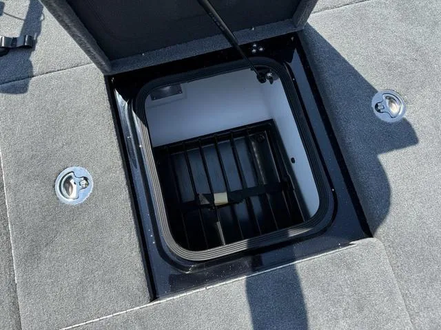 Slide: The Image of Bass Cat Cougar FTD 2025 boat storage compartment with open lid. - 23