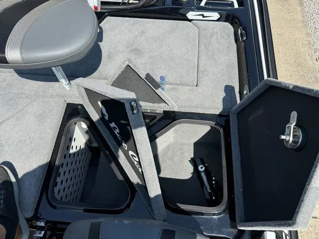 Slide: The Image of 2025 Bass Cat Cougar FTD boat storage compartments with open lids and seating. - 32
