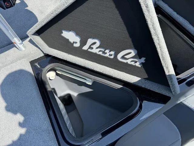 Slide: The Image of 2025 Bass Cat Cougar FTD boat storage compartment with logo detail. - 33