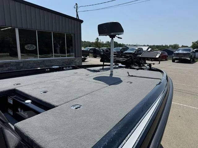 Slide: The Image of 2025 Bass Cat Cougar FTD boat deck in a parking lot, showcasing fishing equipment. - 7