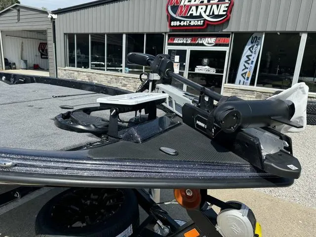 Slide: The Image of 2025 Phoenix 921 ELITE boat with trolling motor at dealership. - 11