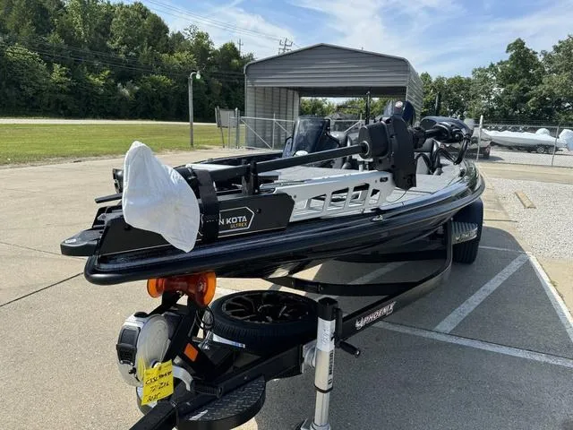 Slide: The Image of 2025 Phoenix 921 ELITE fishing boat on trailer in outdoor setting. - 13