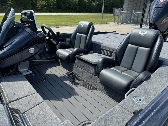 Slide: The Image of 2025 Phoenix 921 ELITE boat interior with sleek black seating and modern dashboard. - 17
