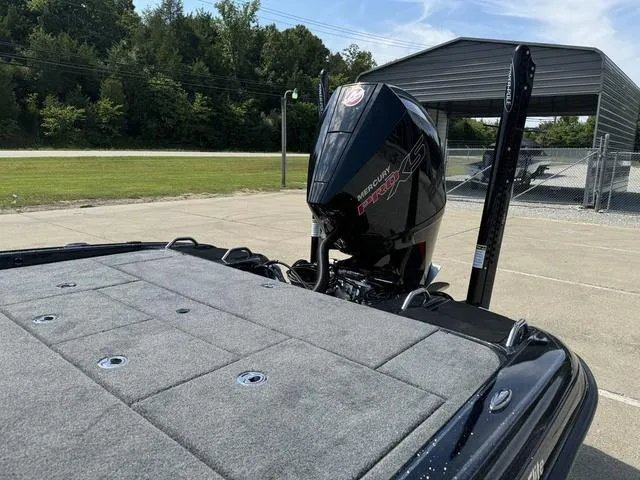 Slide: The Image of 2025 Phoenix 921 ELITE boat with Mercury Pro XS engine in a parking area. - 18