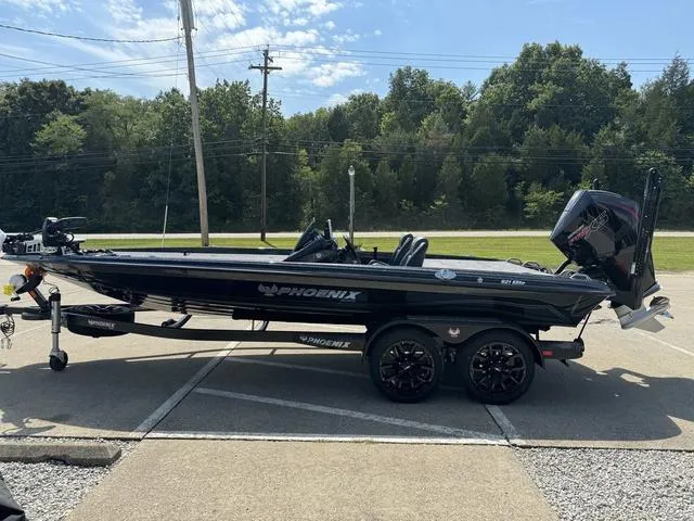 Slide: The Image of 2025 Phoenix 921 ELITE boat on trailer, parked outdoors, side view. - 19