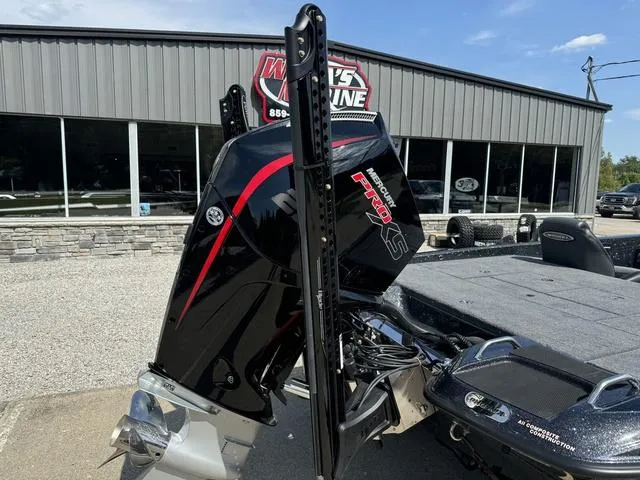 Slide: The Image of 2025 Phoenix 921 ELITE boat with powerful engine, parked outside dealership. - 3