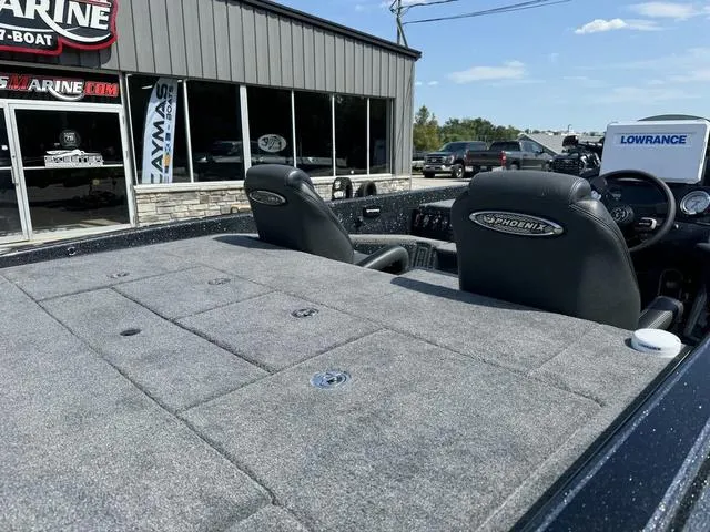 Slide: The Image of 2025 Phoenix 921 ELITE boat interior with seats, outside marine dealership. - 5