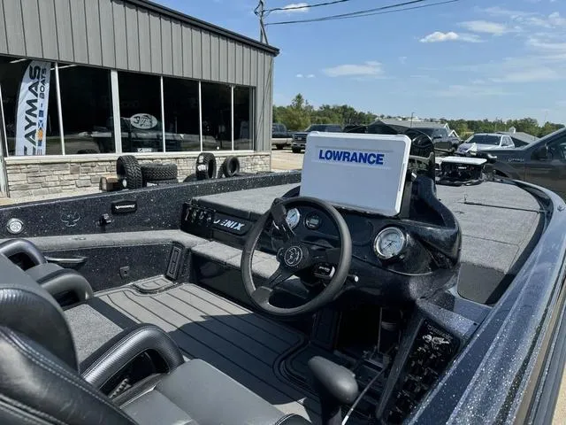 Slide: The Image of 2025 Phoenix 921 ELITE boat interior with Lowrance navigation system, parked outside dealership. - 6