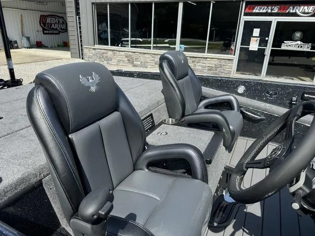 Slide: The Image of 2025 Phoenix 921 ELITE boat interior with black leather seats and steering wheel. - 7