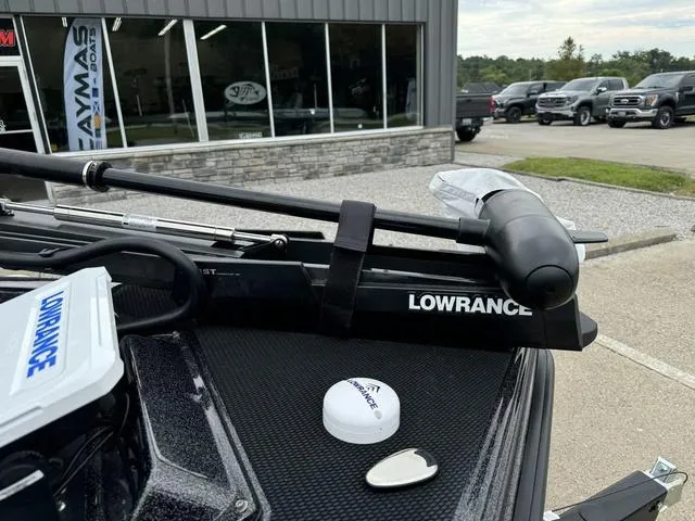 Slide: The Image of Phoenix 920 Elite 2025 boat with Lowrance equipment, parked outside dealership. - 12