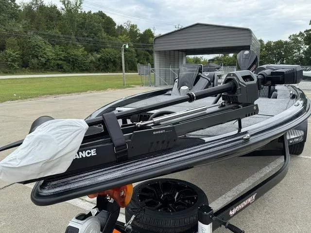 Slide: The Image of Phoenix 920 Elite 2025 boat with advanced trolling motor, parked outdoors. - 14