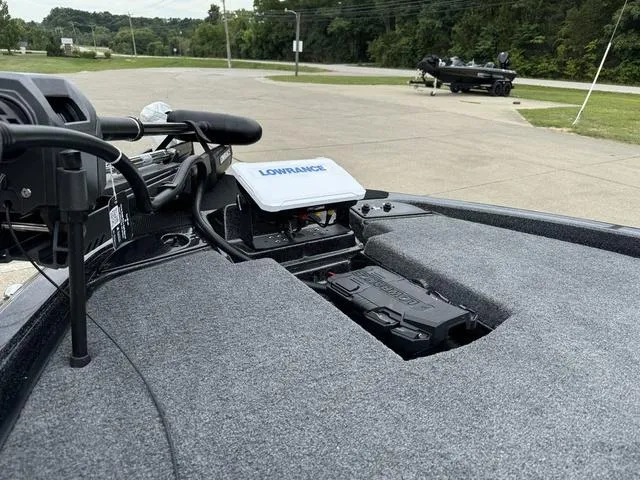 Slide: The Image of 2025 Phoenix 920 Elite boat with Lowrance electronics, parked on a concrete surface. - 16