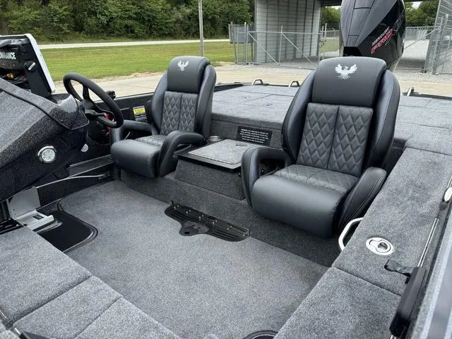 Slide: The Image of 2025 Phoenix 920 Elite boat interior with black leather seats and steering wheel. - 18