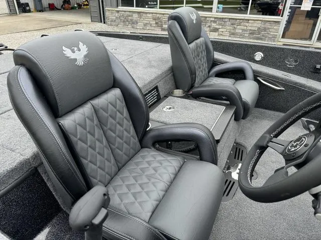 Slide: The Image of Phoenix 920 Elite 2025 boat interior with luxurious leather seats and modern steering wheel. - 7