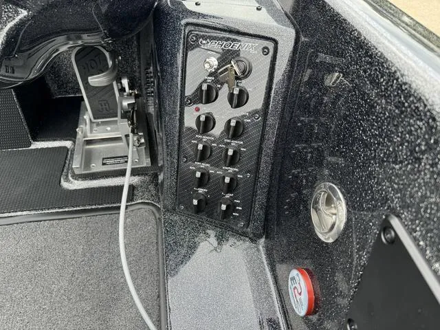 Slide: The Image of Control panel of 2025 Phoenix 920 Elite boat with switches and key ignition. - 8