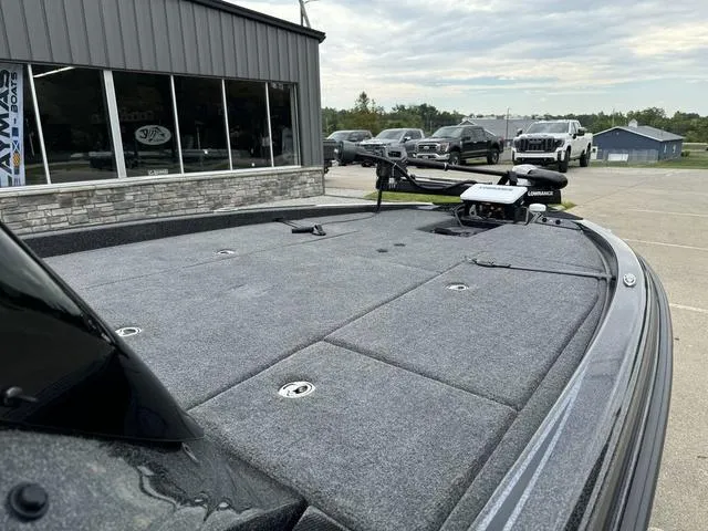 Slide: The Image of 2025 Phoenix 920 Elite boat deck, gray carpet, outdoor showroom display. - 9