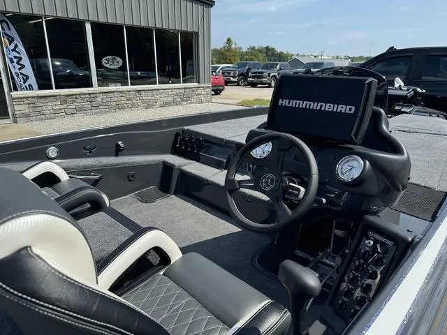 Slide: The Image of 2025 Phoenix 721 ZXL boat interior with steering wheel and Humminbird electronics. - 11