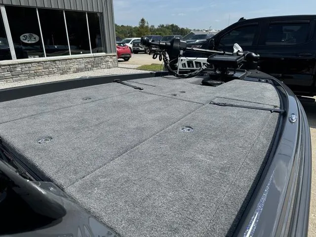 Slide: The Image of 2025 Phoenix 721 ZXL boat deck with trolling motor, parked outdoors. - 14