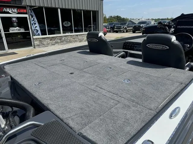 Slide: The Image of 2025 Phoenix 721 ZXL boat interior with gray carpeted deck and seating. - 4